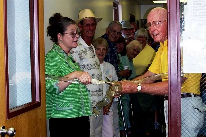 People gathered for a ribbon-cutting celebration inside Alexandria Public Library